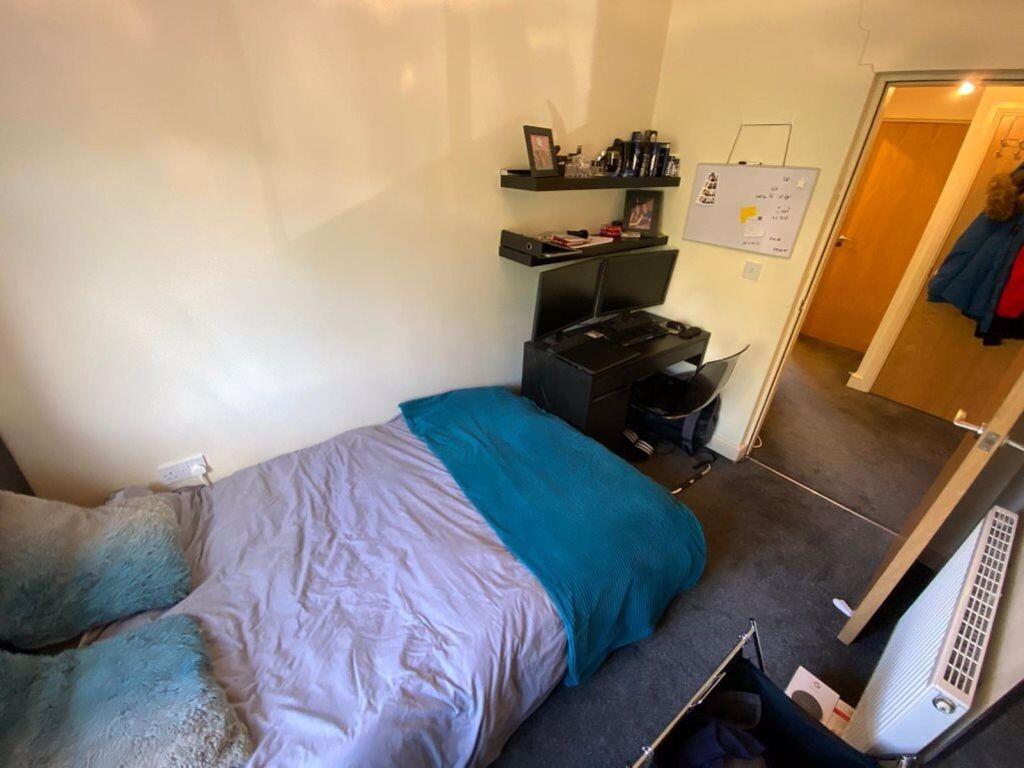 A cozy double bedroom featuring a bed with a bl...