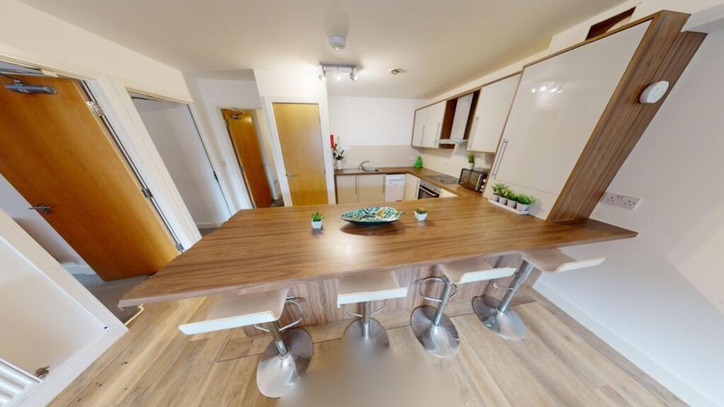 A modern kitchen featuring a spacious wooden co...