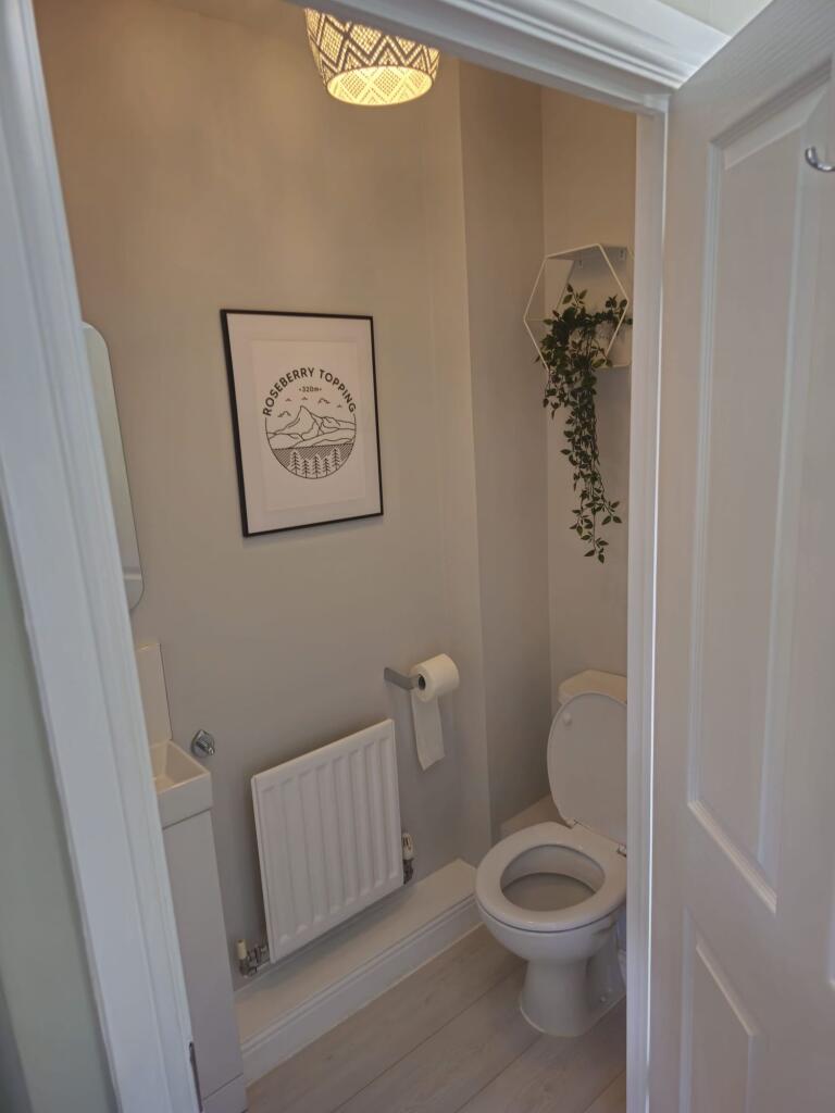 A neat and well-maintained small toilet room fe...