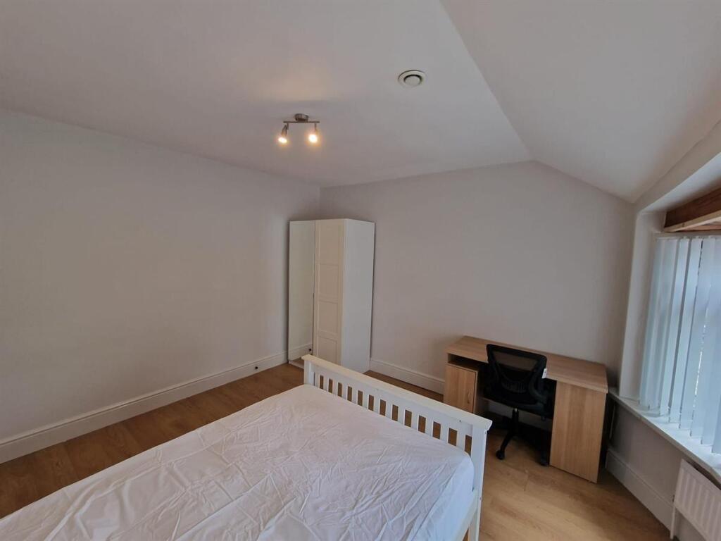 Bright, neutrally decorated double bedroom with...