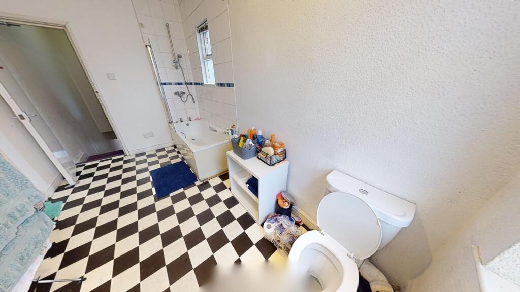 Bright and clean bathroom featuring a classic b...