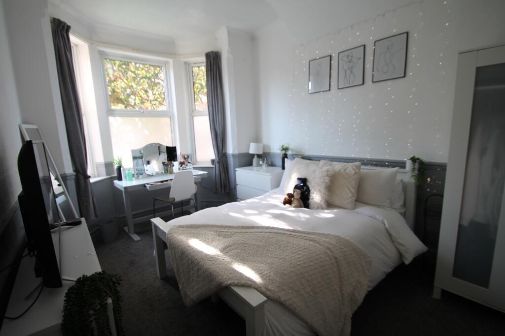 Bright and cozy double bedroom featuring a comf...