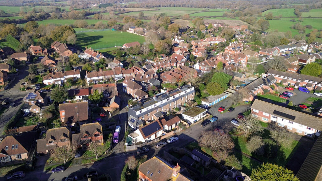 Aerial view over the house and open countryside and walks beyond