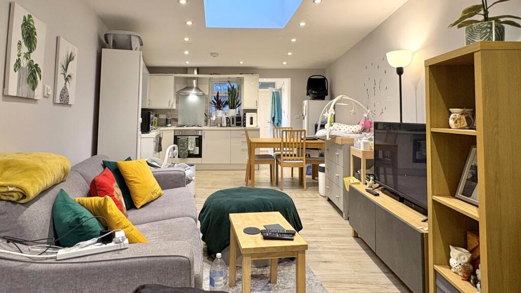 Bright, modern open-plan living area with conte...