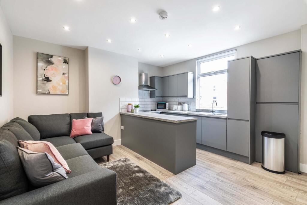 A modern, bright living room featuring a comfor...