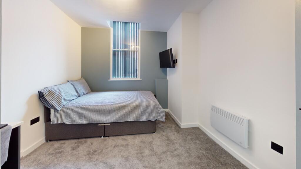 A bright and inviting double bedroom with moder...