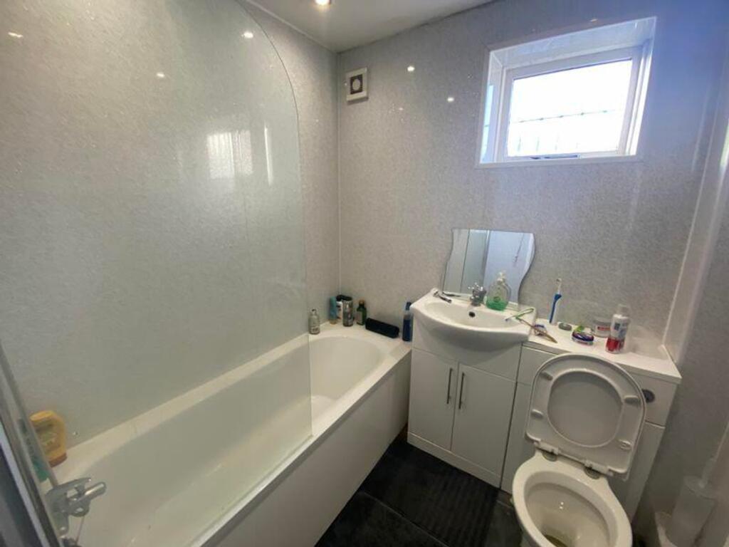 A modern and clean bathroom featuring a bath an...