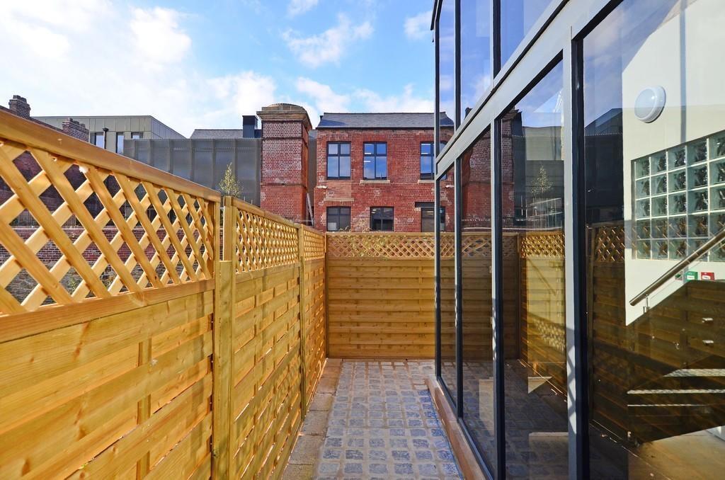 A bright and well-maintained garden space featu...