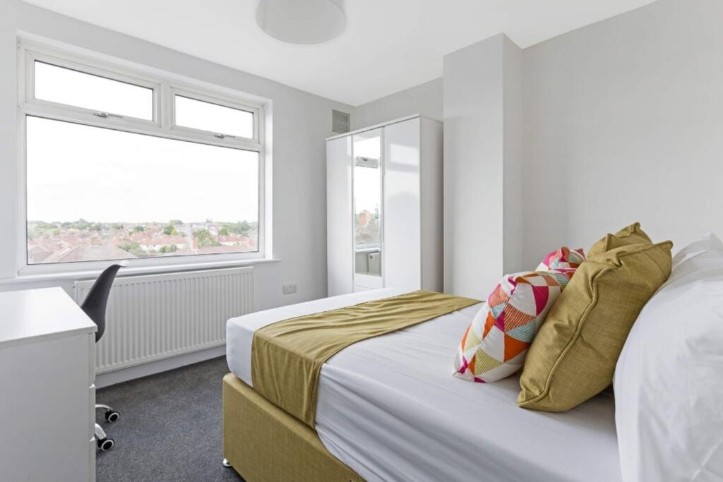 A bright and spacious double bedroom featuring ...