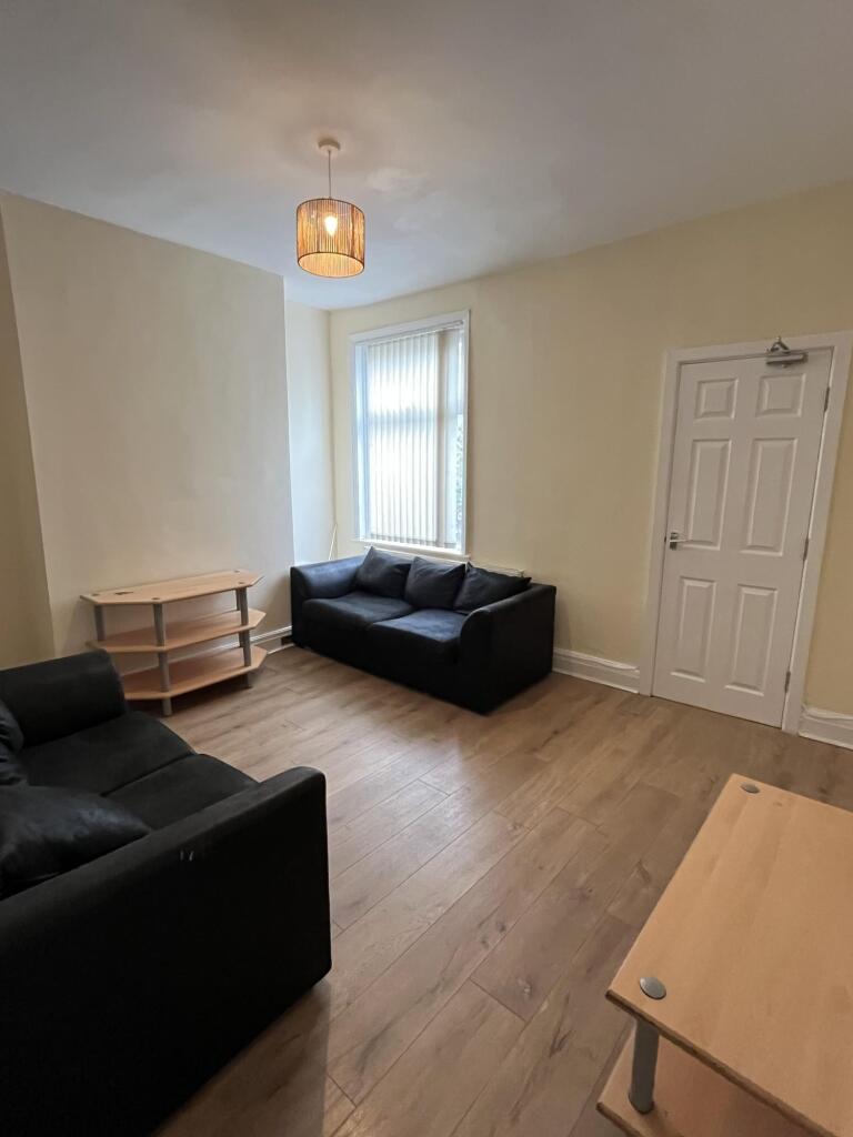 A neat and inviting living room featuring two b...