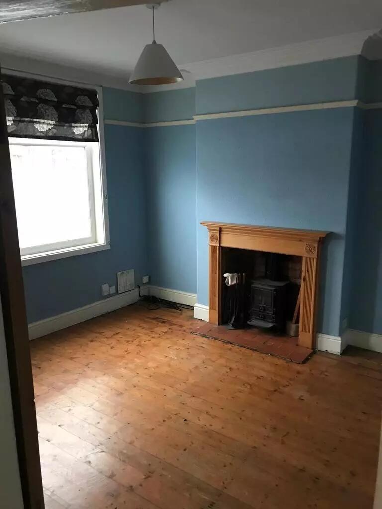 A charming living room featuring natural wood f...