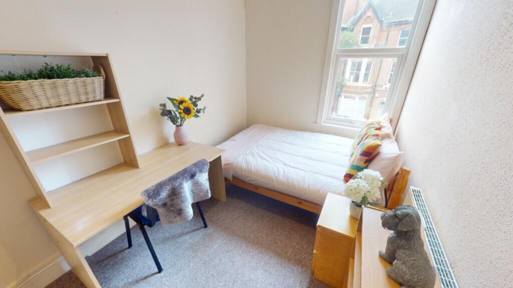A bright and tidy double bedroom featuring a co...