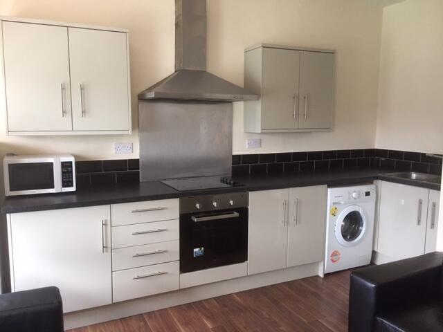 A well-maintained modern kitchen featuring whit...