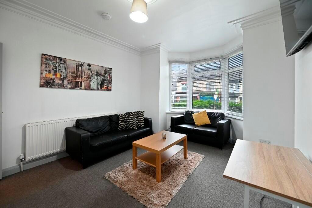 A bright and inviting living room featuring com...