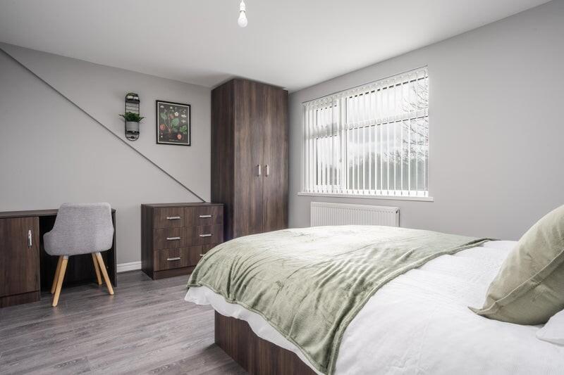 This inviting double bedroom features a cozy be...