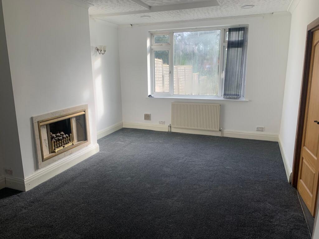 A bright and spacious living room featuring a l...