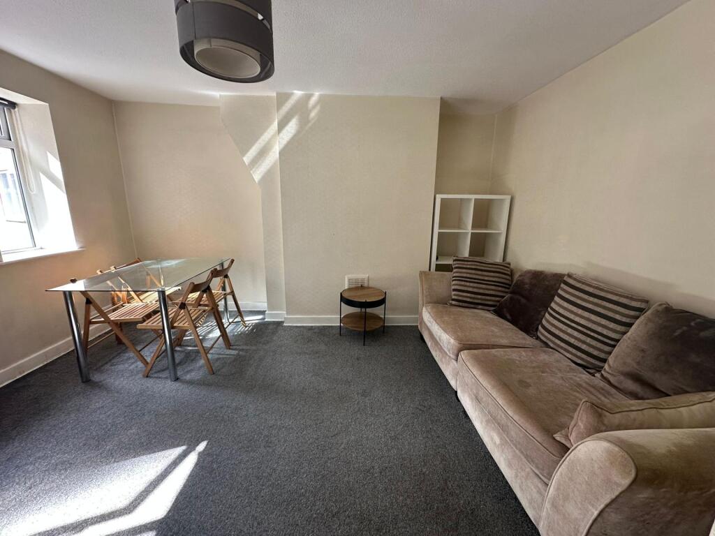 A cozy living room featuring a comfortable sofa...