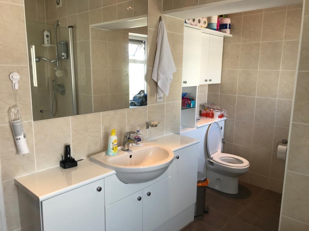 A modern bathroom featuring a large mirror abov...
