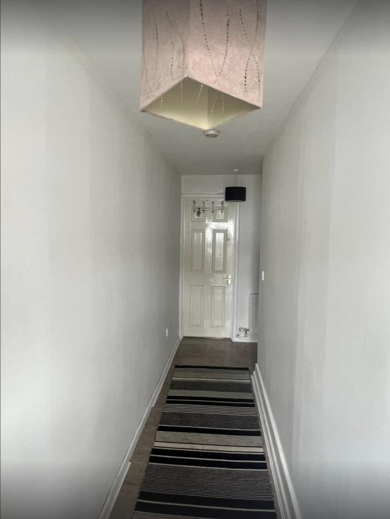 A clean and well-maintained hallway with neutra...