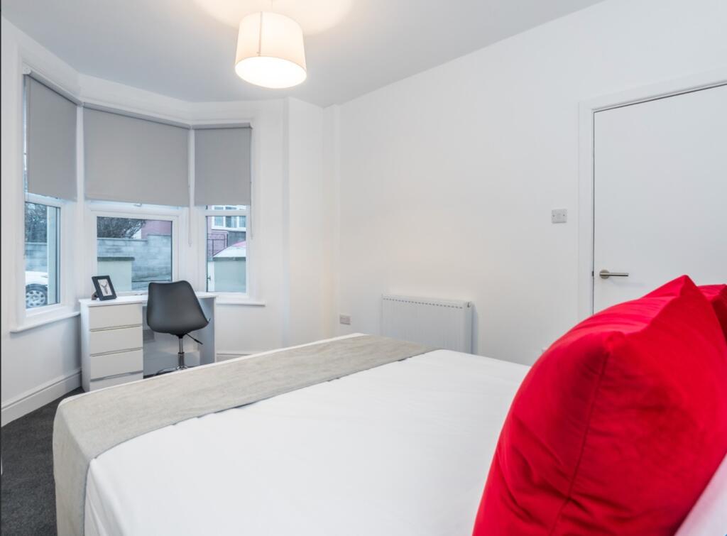 A bright and inviting double bedroom featuring ...