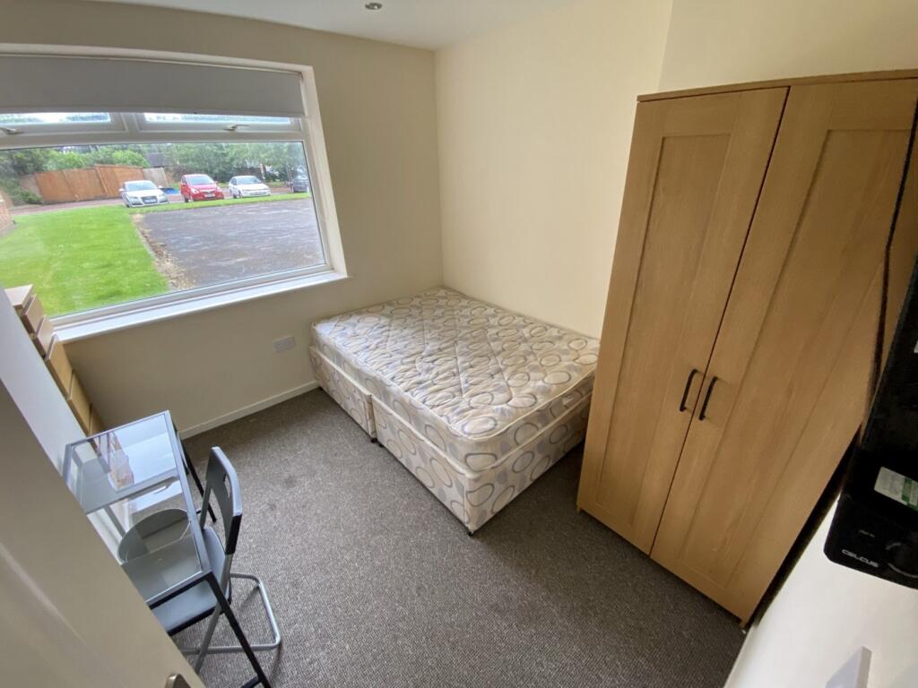 A bright and tidy double bedroom with a comfort...