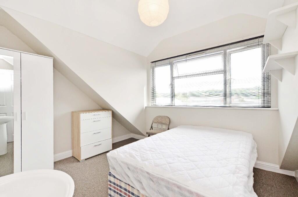 Bright and cozy double bedroom featuring a comf...