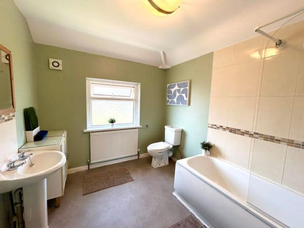 A bright and spacious bathroom suite featuring ...
