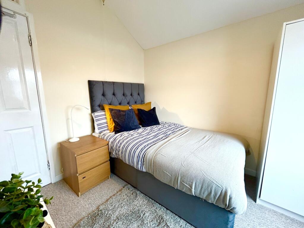 This inviting double bedroom features a comfort...