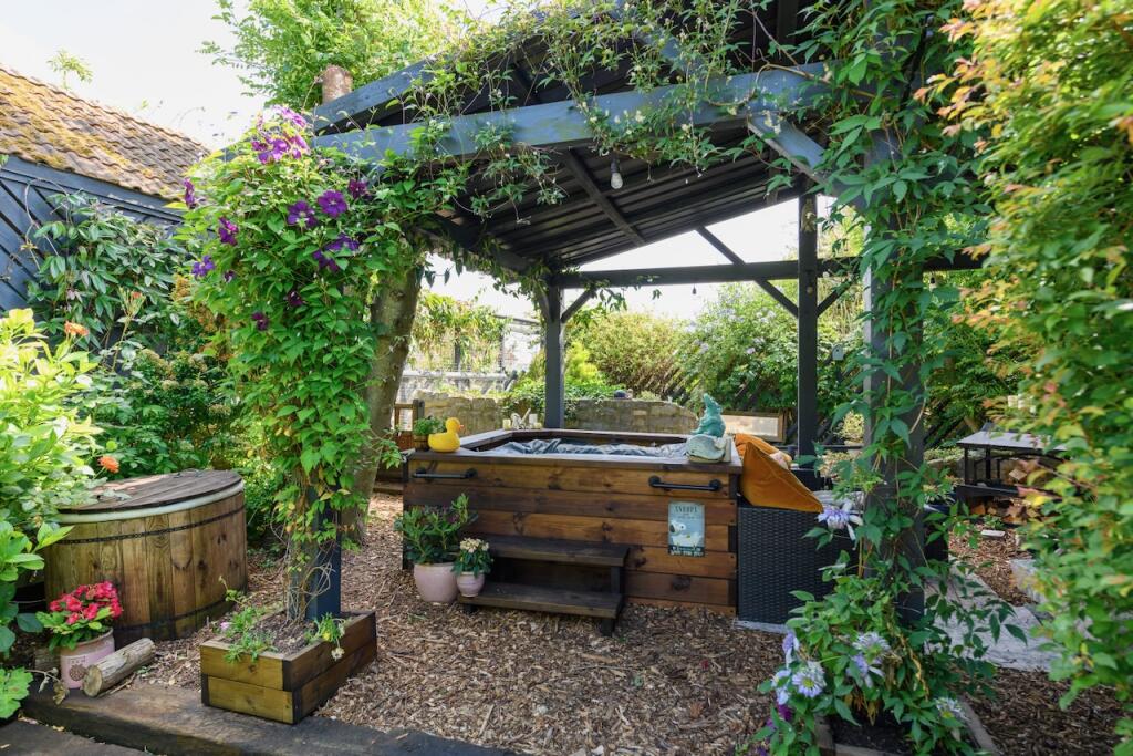 Hot tub and outdoor covered seating area