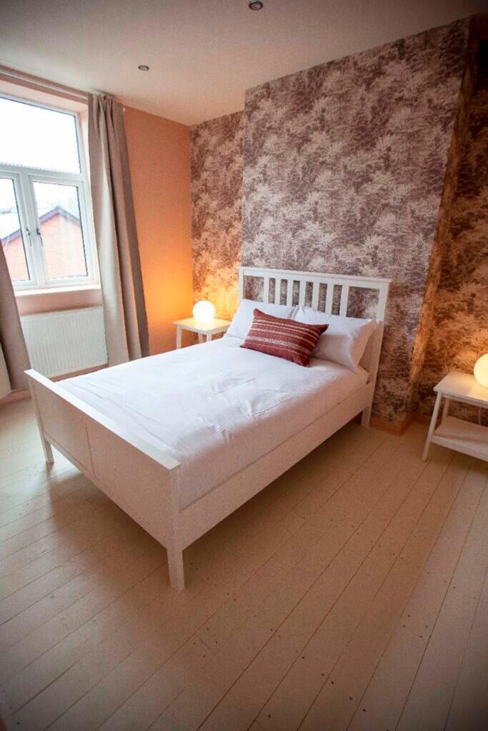 A bright and inviting double bedroom featuring ...