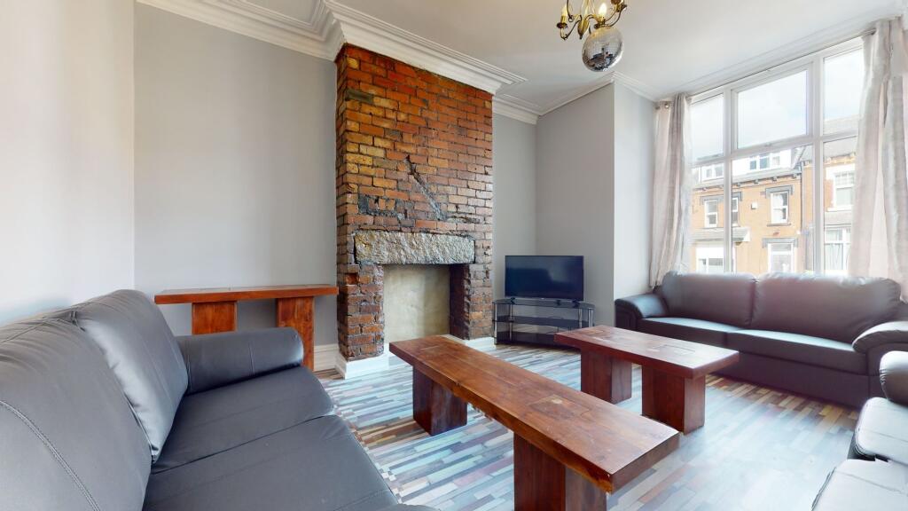 Bright and spacious living room with large wind...