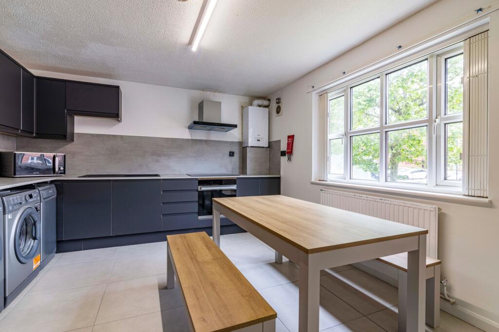 A modern and spacious kitchen featuring ample n...