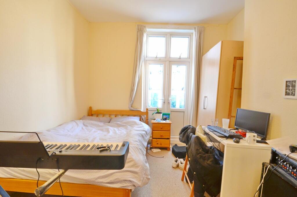 Cozy and bright bedroom featuring a large windo...