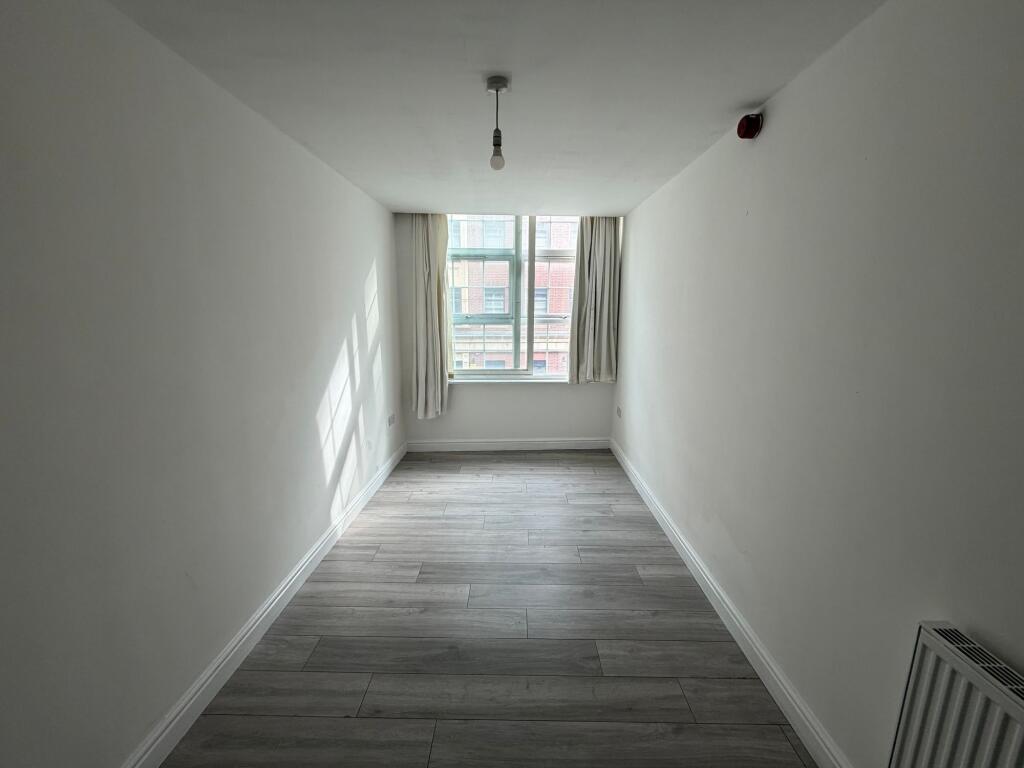 Bright and airy living room with large window a...