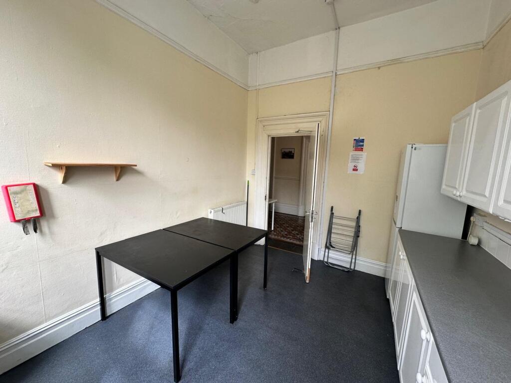 A functional kitchenette with ample space for c...