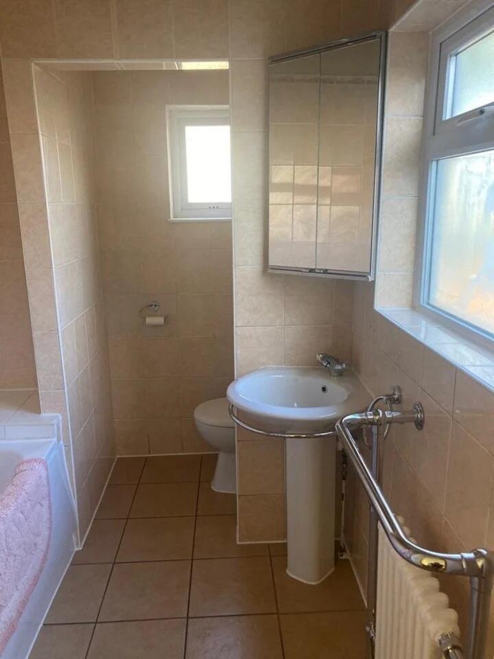 A clean and bright bathroom featuring a pedesta...