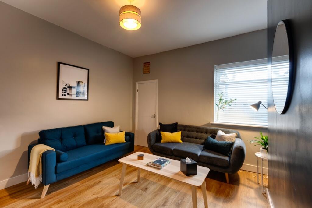 A modern, well-lit living room featuring two st...