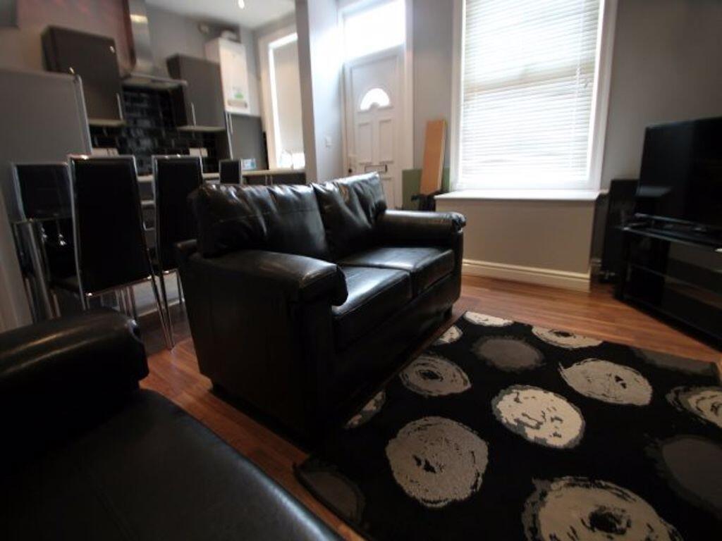A cozy living room featuring comfortable black ...