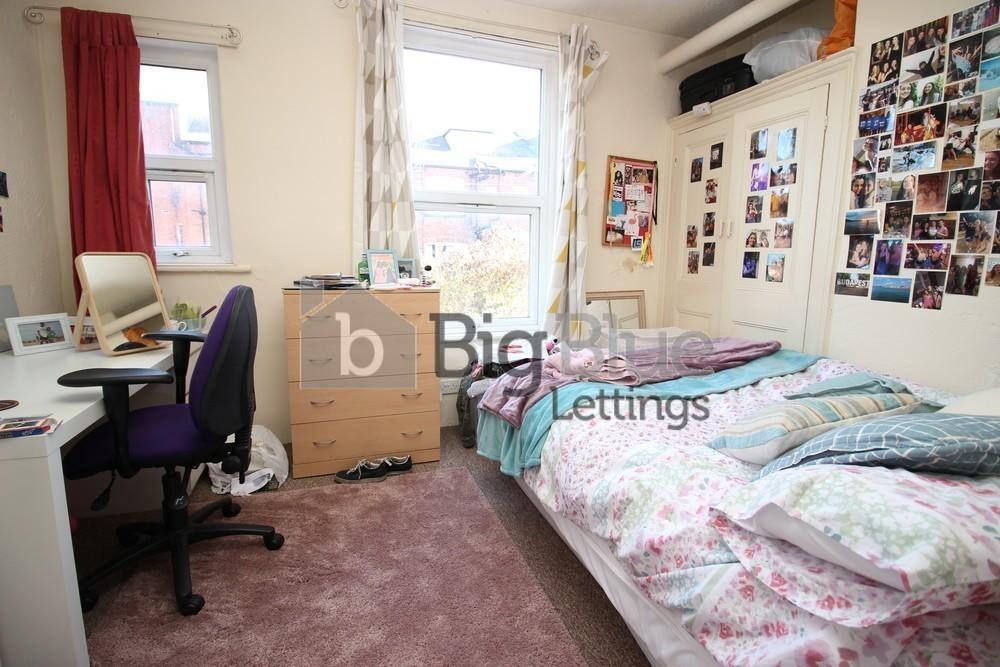 Bright and tidy student bedroom featuring a sin...