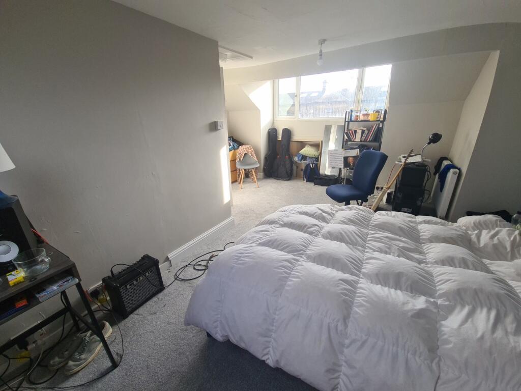 Bright and spacious master bedroom featuring a ...