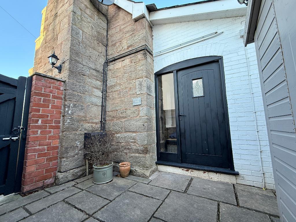 Front door to cottage at the side