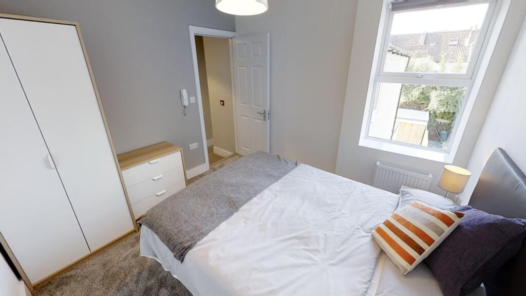 Bright and cozy double bedroom featuring a comf...