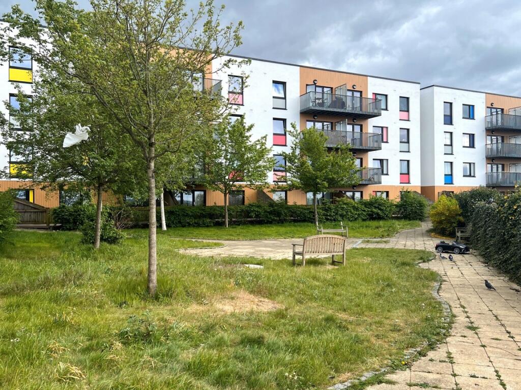 A well-maintained garden area with green grass,...