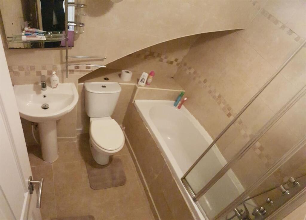 Well-maintained bathroom with a white basin, WC...