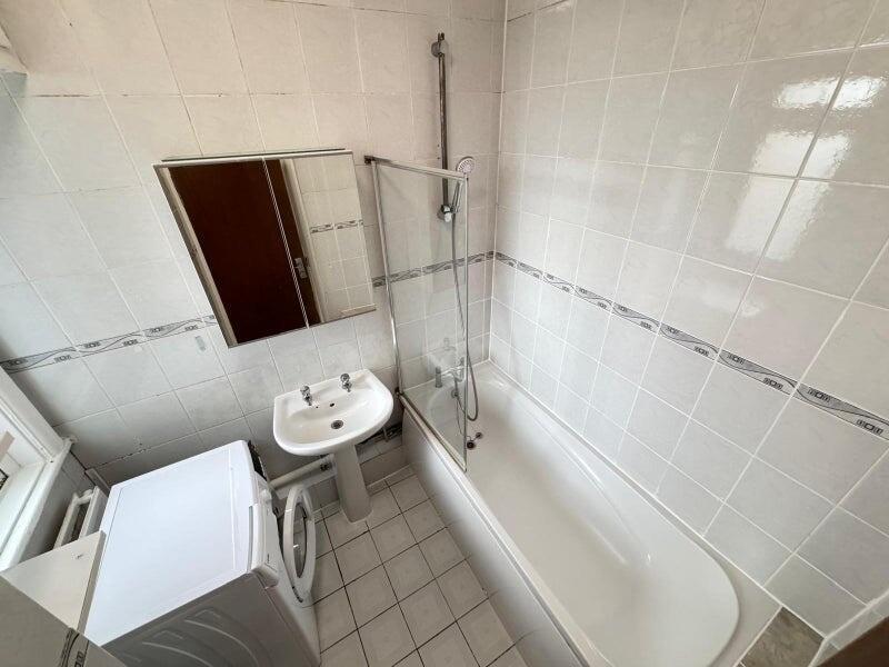 Well-maintained bathroom featuring a clean whit...