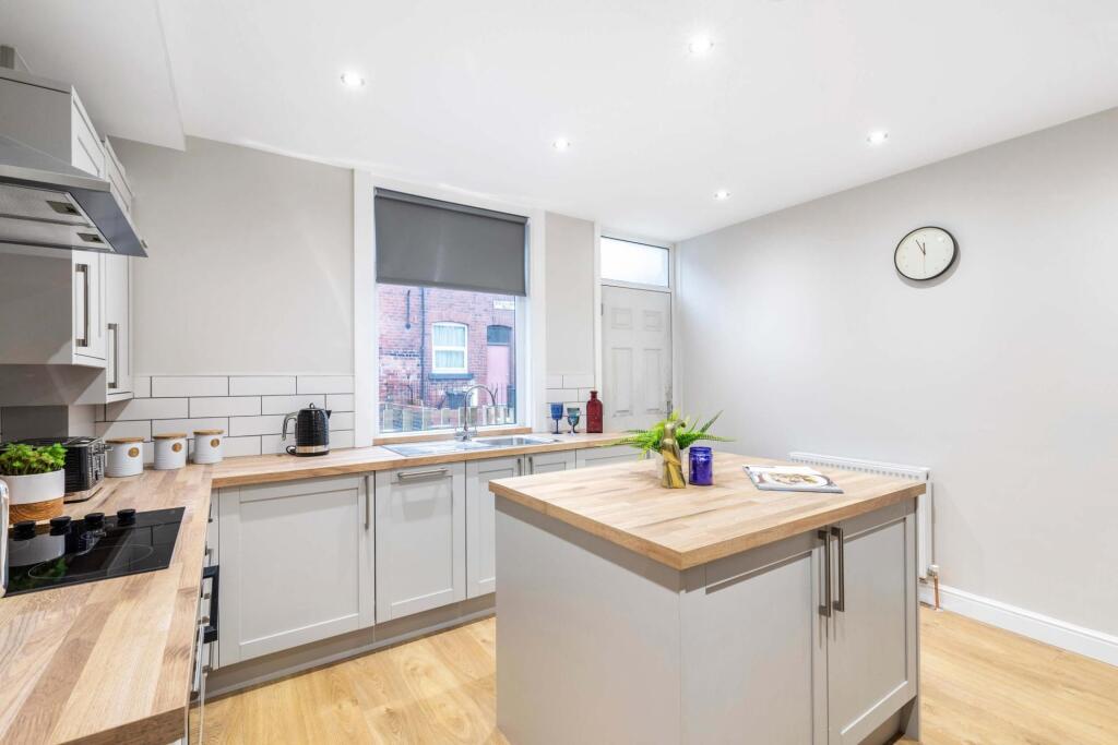 Bright, modern kitchen with a central island, w...