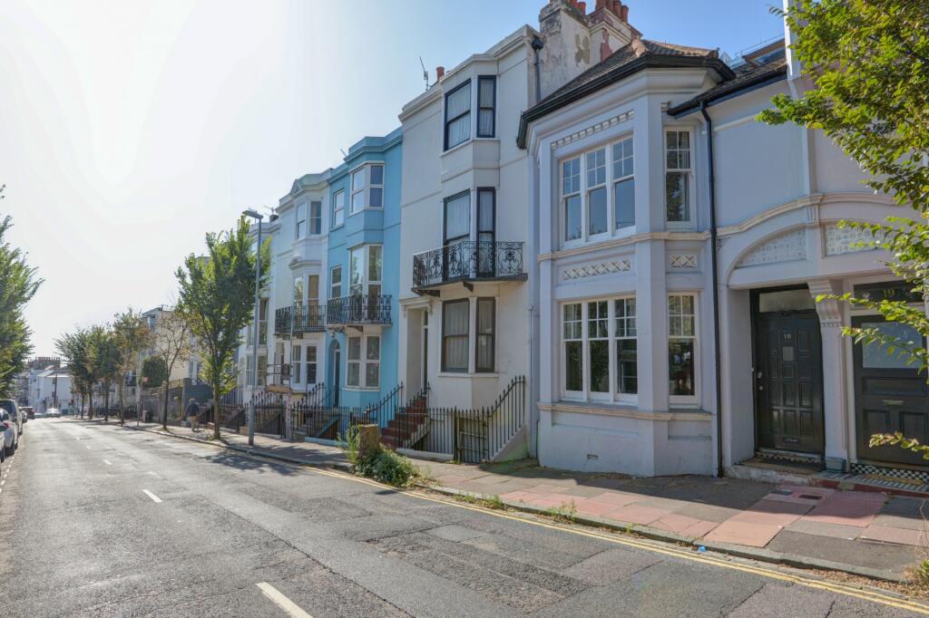 A charming row of terraced houses bathed in nat...