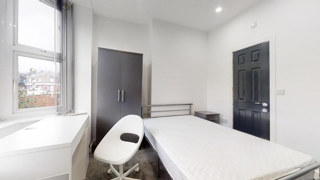 Bright and minimalistic single bedroom featurin...