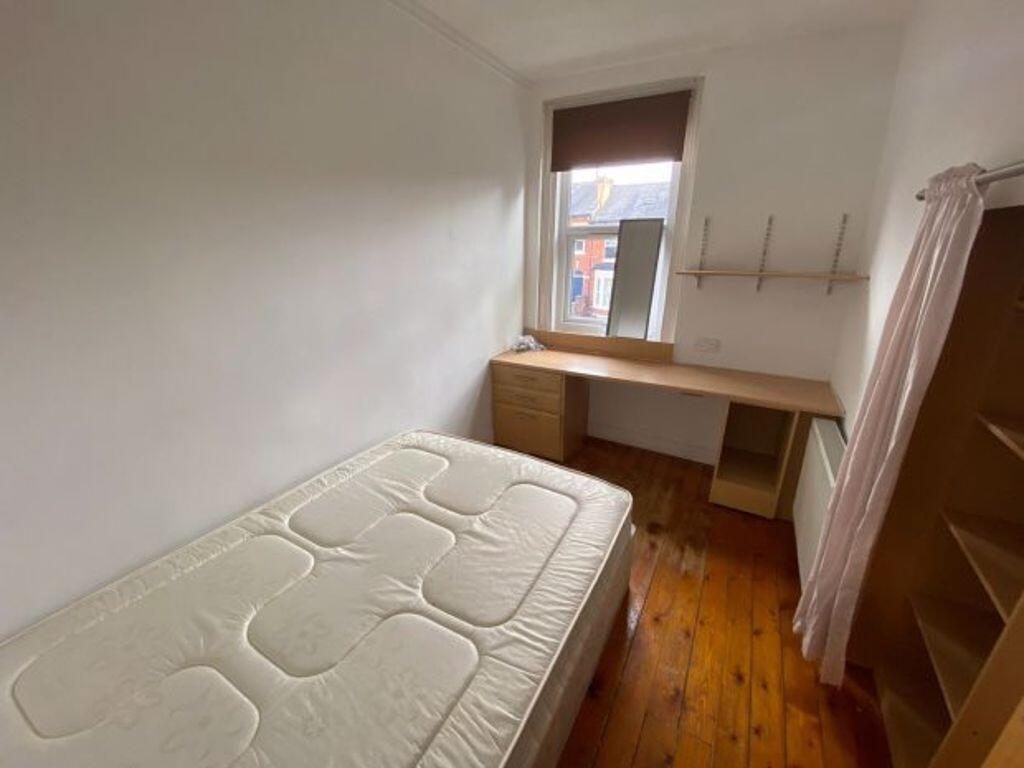 A cozy single bedroom featuring a comfortable m...