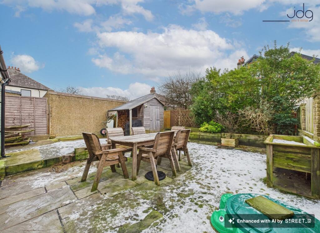 Landscaped East facing rear garden offering privacy, patio seating, and useful storage